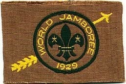 Arrowe Park, Birkenhead, England, 1929. The coming of age Jamboree celebrating Scouting's 21st anniversary. 69 countries represented by 50,000 Scouts (320,000 visitors!). B-P blew the kudu horn at the opening. The first Scout Promise. B-P became Lord Baden-Powell of Gilwell. Also the "Jamboree of Mud". A golden arrow and a hatchet were buried. Gilded wooden arrows were presented to national contingents. B-P said, "Now I send you forth to your
homeland bearing the sign of peace, goodwill and fellowship to all your fellow men. From now on the symbol of peace and goodwill is a golden arrow. Carry that arrow on and on, so that all may know of the brotherhood of men."