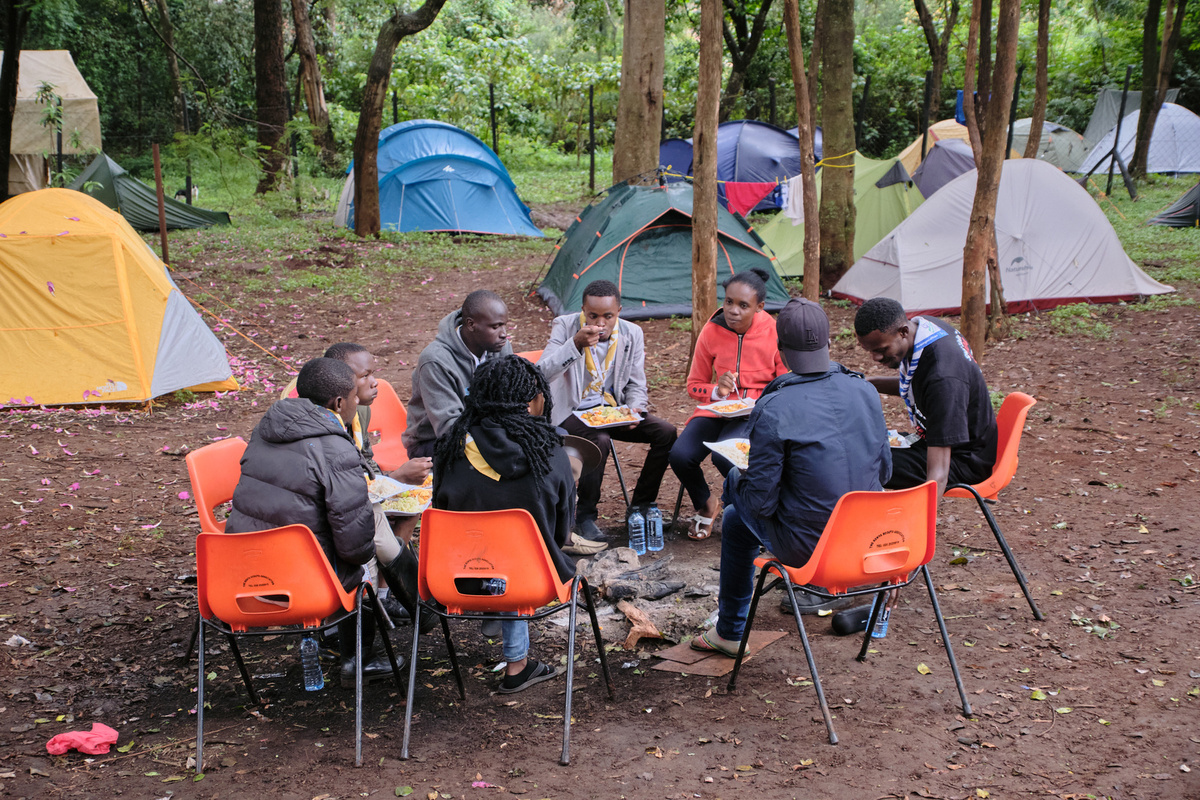 Everyday life during the 1st Africa Rover Moot – playing football or cards, washing clothes, chatting and having lunch together, making new friends and learning something new.